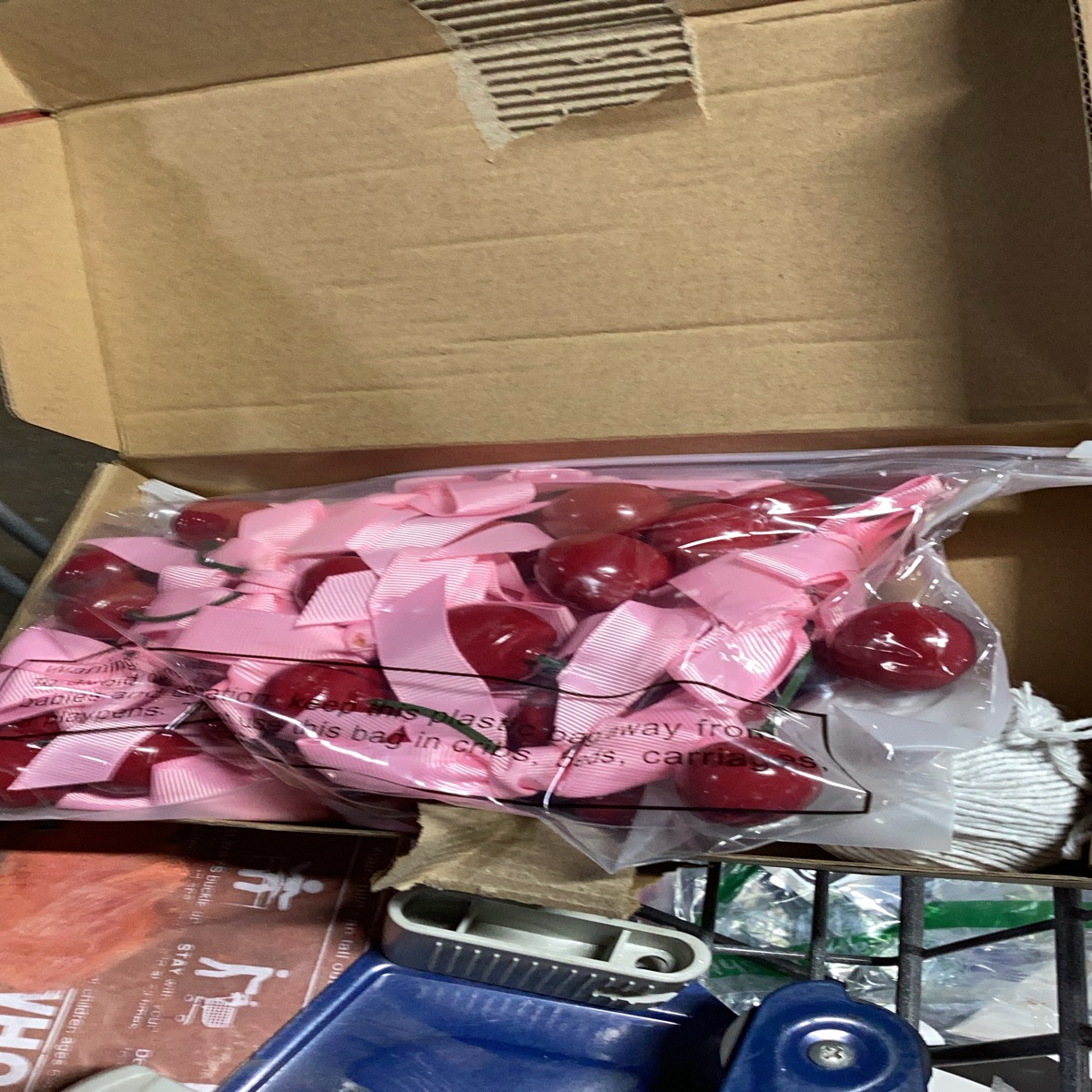 Cherry and pink Bows. Comes with spool Of yarn